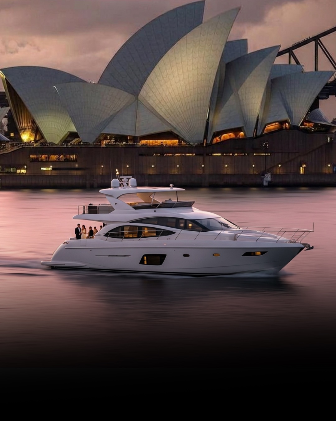 A charter vessel on the harbour at dusk with the illuminated Sydney Opera House behind.
